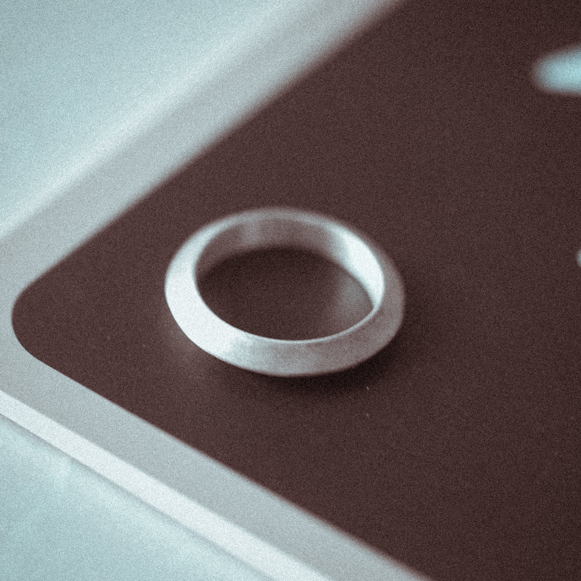 Silver ring on a textured brown surface