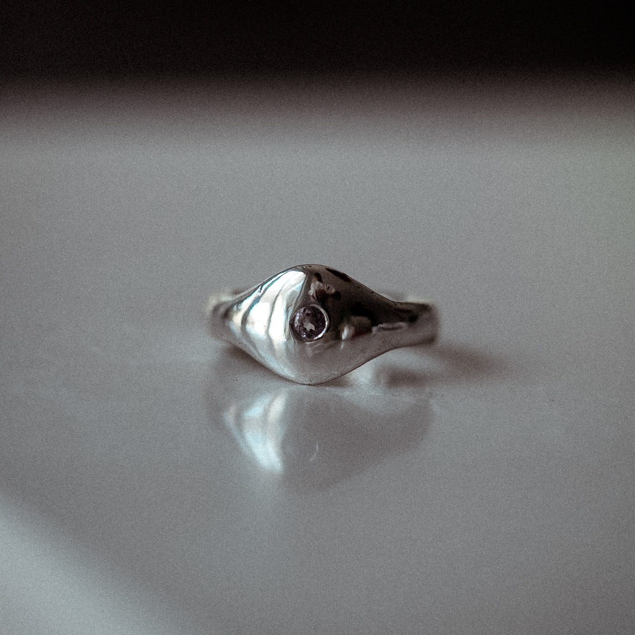 Front view of The Last Light organic sterling silver signet ring