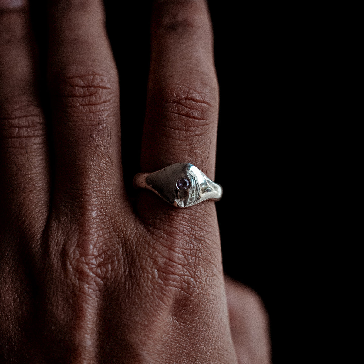Handmade sterling silver amethyst ring worn at an angle